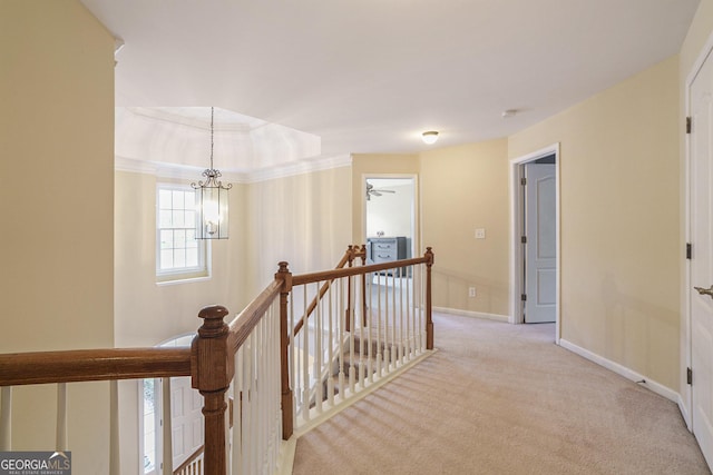 hallway featuring baseboards, an inviting chandelier, an upstairs landing, and light colored carpet