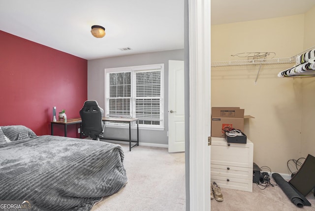 bedroom featuring light carpet, visible vents, and baseboards