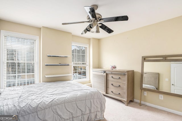 carpeted bedroom featuring ceiling fan and baseboards