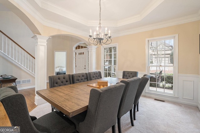 dining space featuring arched walkways, visible vents, and ornate columns