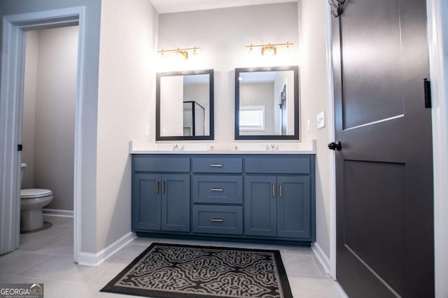 full bath with tile patterned flooring, double vanity, toilet, and baseboards