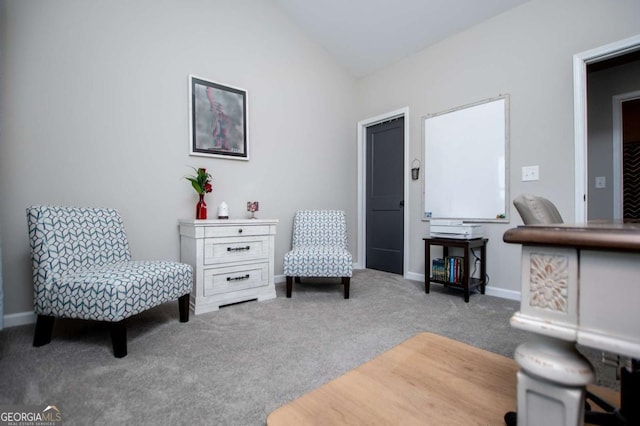sitting room with carpet floors, lofted ceiling, and baseboards