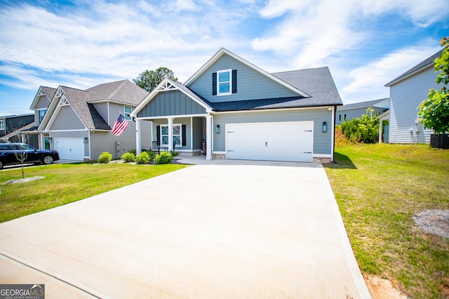 view of front of home with board and batten siding, a porch, a front yard, and concrete driveway