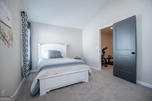 bedroom featuring light carpet and baseboards