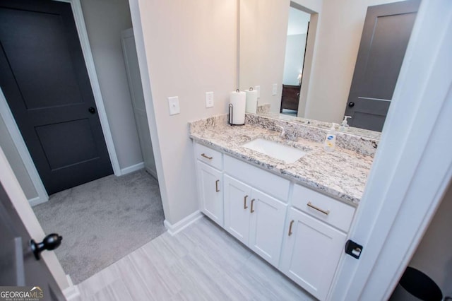 bathroom featuring vanity and baseboards