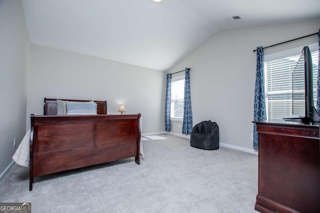 bedroom with vaulted ceiling, carpet flooring, and baseboards