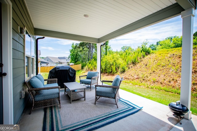 view of patio / terrace with outdoor lounge area and fence