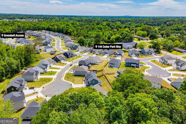 aerial perspective of suburban area with a forest