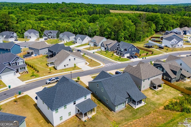 aerial perspective of suburban area featuring a heavily wooded area