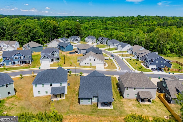 aerial perspective of suburban area featuring a forest