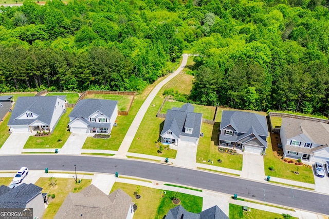 aerial perspective of suburban area with a heavily wooded area