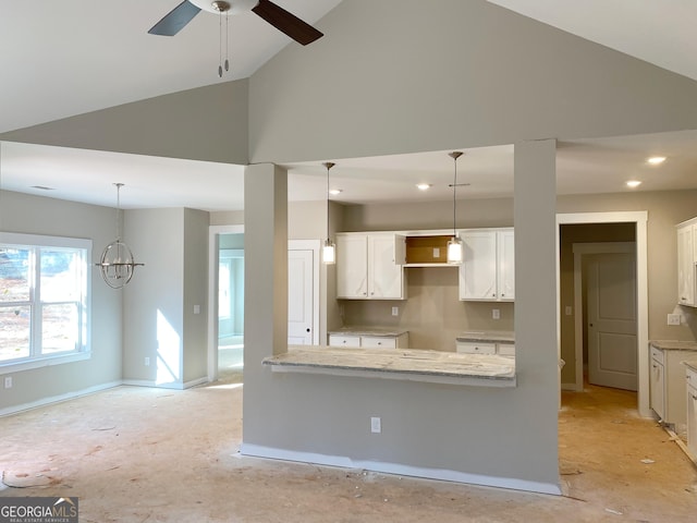 kitchen featuring white cabinetry, decorative light fixtures, a ceiling fan, and high vaulted ceiling