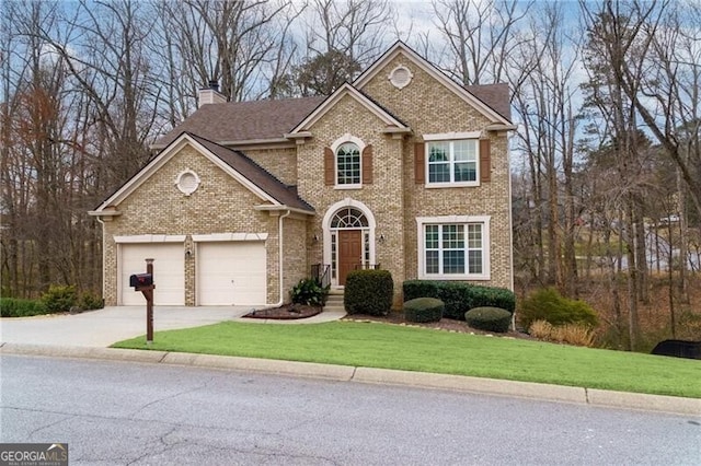 traditional-style house featuring brick siding, driveway, a chimney, and a front lawn