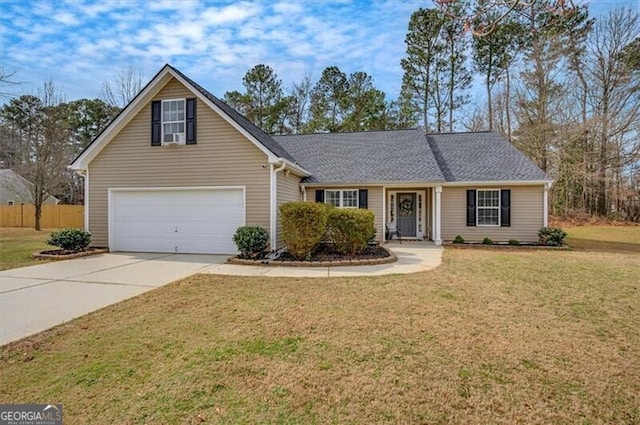 view of front facade featuring driveway, a garage, fence, and a front yard