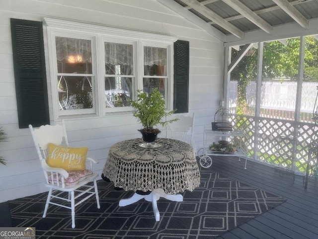 sunroom with lofted ceiling with beams