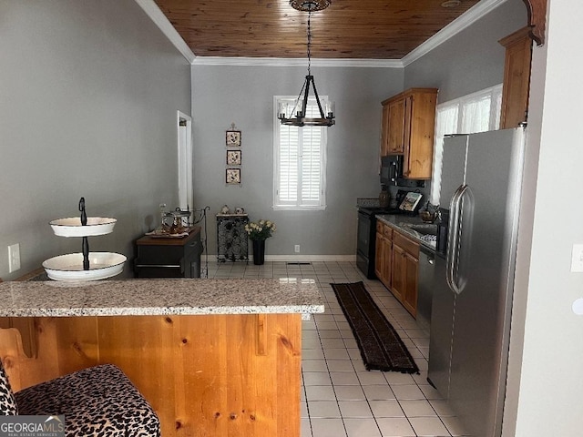 kitchen featuring a peninsula, a kitchen breakfast bar, light countertops, brown cabinets, and black appliances