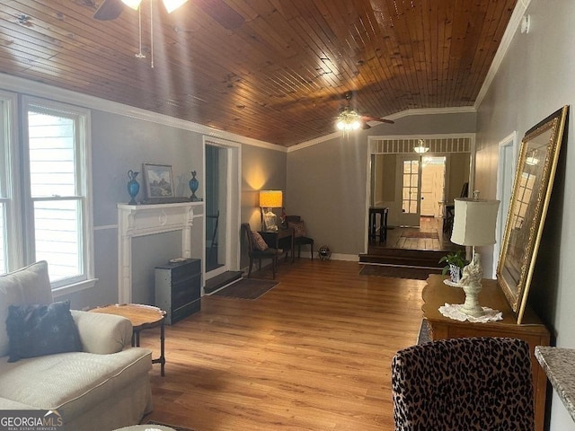 living area featuring light wood-type flooring, wooden ceiling, a fireplace, and crown molding