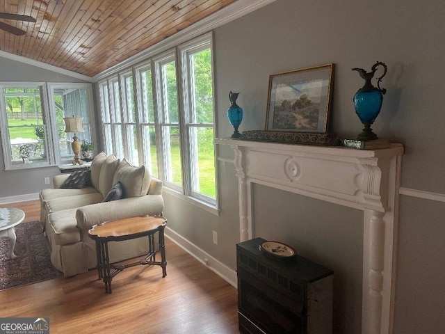 living area with light wood-type flooring, wooden ceiling, lofted ceiling, and baseboards