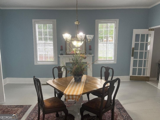 dining room with baseboards, a chandelier, and crown molding