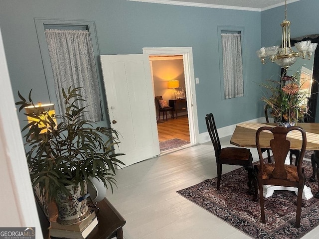 dining space featuring crown molding and wood finished floors