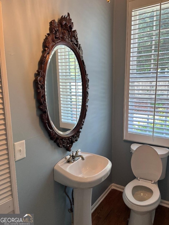 bathroom featuring baseboards, toilet, and wood finished floors