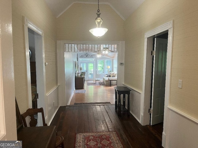 hall featuring lofted ceiling and dark wood-style flooring