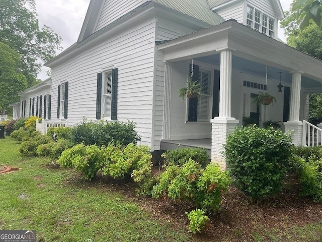 view of property exterior featuring covered porch