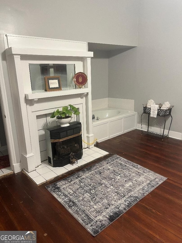 living area with baseboards and wood finished floors