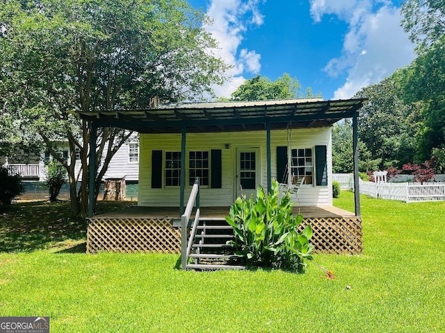 view of front of property featuring metal roof, a porch, fence, stairs, and a front yard