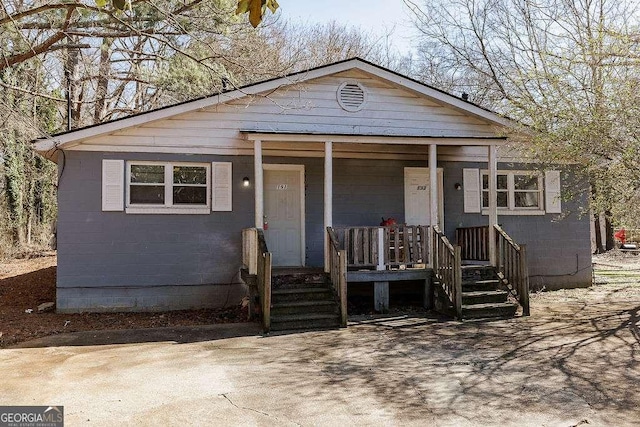 view of front of property with concrete block siding and covered porch