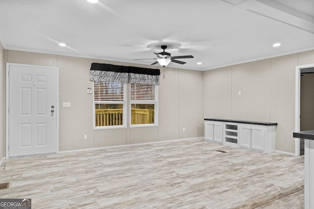 spare room featuring light wood-type flooring, ceiling fan, ornamental molding, and recessed lighting