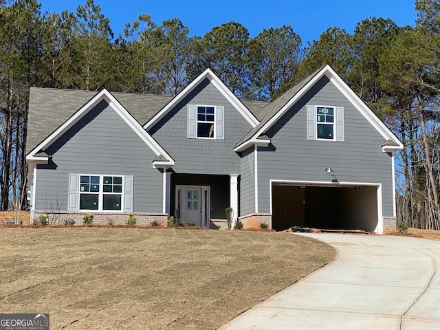 craftsman-style house with driveway, an attached garage, and a front yard