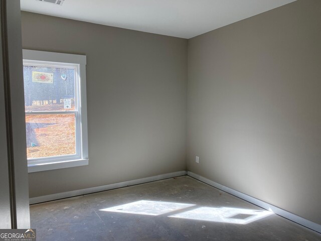 unfurnished room with visible vents and baseboards