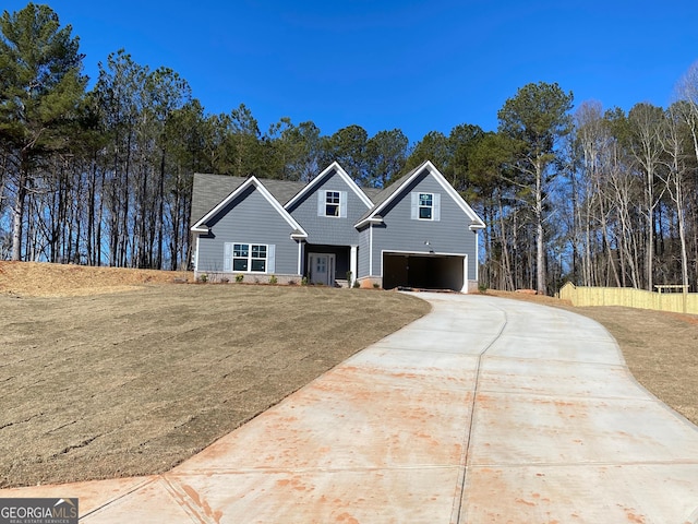 view of front facade featuring a front lawn, concrete driveway, and an attached garage