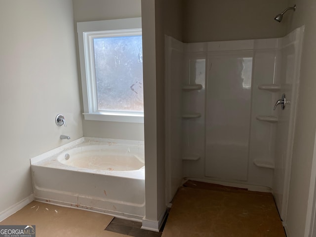 full bath with baseboards, walk in shower, and a bath