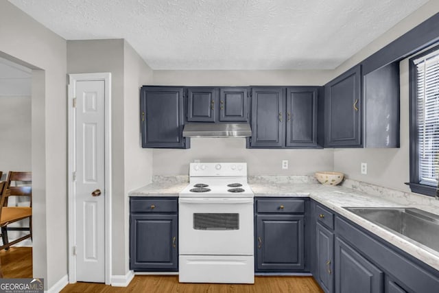 kitchen with light wood finished floors, white electric range oven, light countertops, a sink, and under cabinet range hood