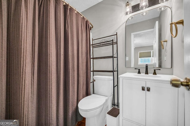 full bathroom with vanity and toilet