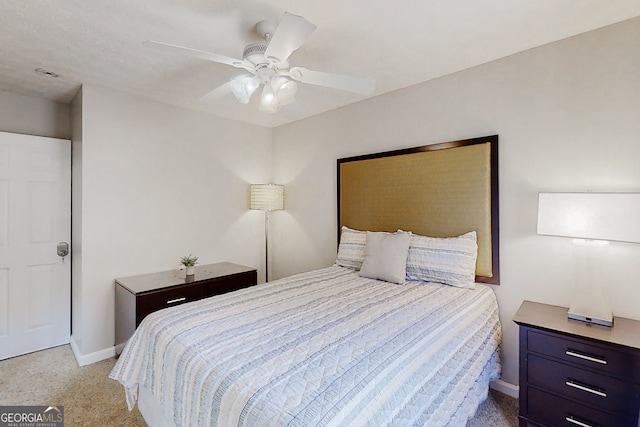 bedroom featuring baseboards, a ceiling fan, and light colored carpet