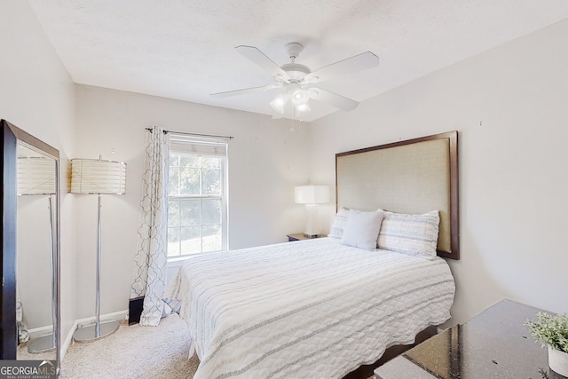 carpeted bedroom with a ceiling fan and baseboards