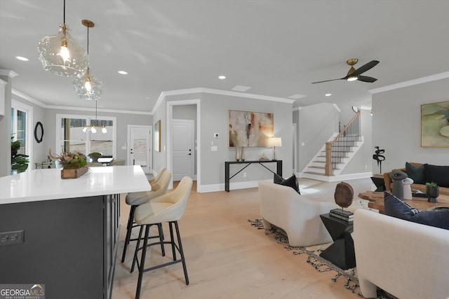 interior space featuring stairs, light wood-type flooring, recessed lighting, and crown molding