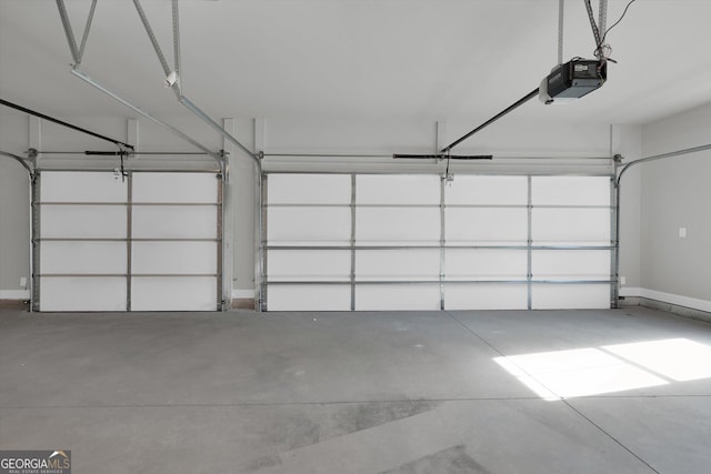 garage with baseboards and a garage door opener