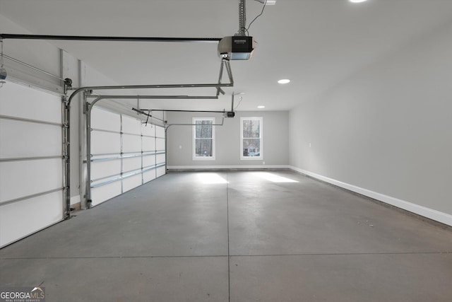 garage featuring a garage door opener, recessed lighting, and baseboards