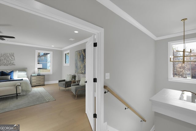 interior space featuring ornamental molding, recessed lighting, light wood-style flooring, and baseboards