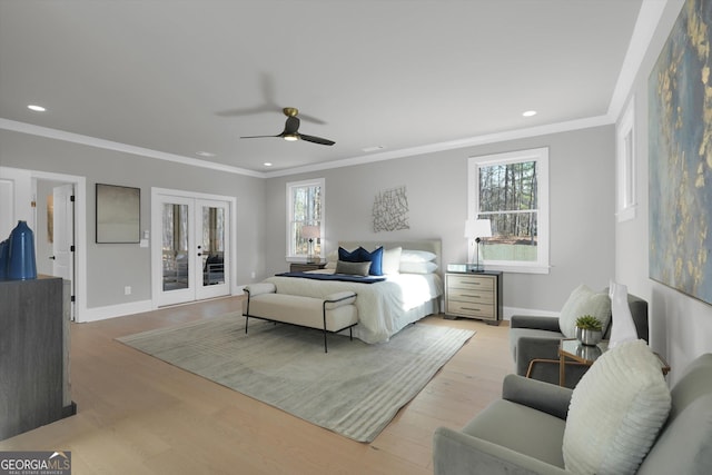 bedroom featuring ornamental molding, french doors, multiple windows, and light wood-style flooring