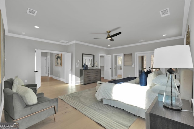 bedroom featuring crown molding, visible vents, wood finished floors, and french doors