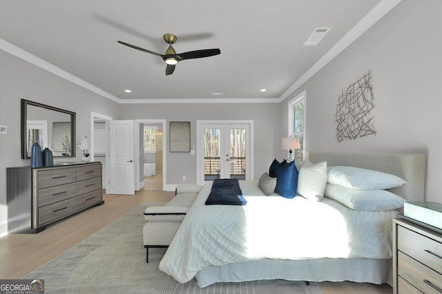 bedroom with french doors, light wood-type flooring, visible vents, and crown molding