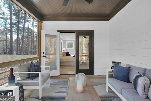 sunroom featuring a ceiling fan