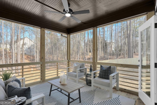 sunroom / solarium with a ceiling fan