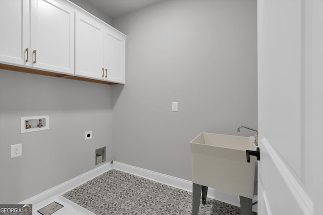 laundry room with cabinet space, baseboards, hookup for a washing machine, electric dryer hookup, and a sink