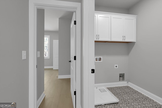 clothes washing area with cabinet space, hookup for a washing machine, electric dryer hookup, and baseboards